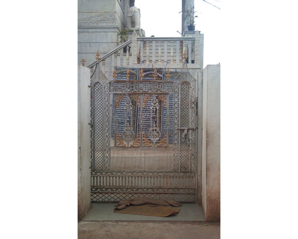 Image of a intricately designed Mandir gate with traditional motifs and ornate carvings, reflecting cultural heritage and spirituality.