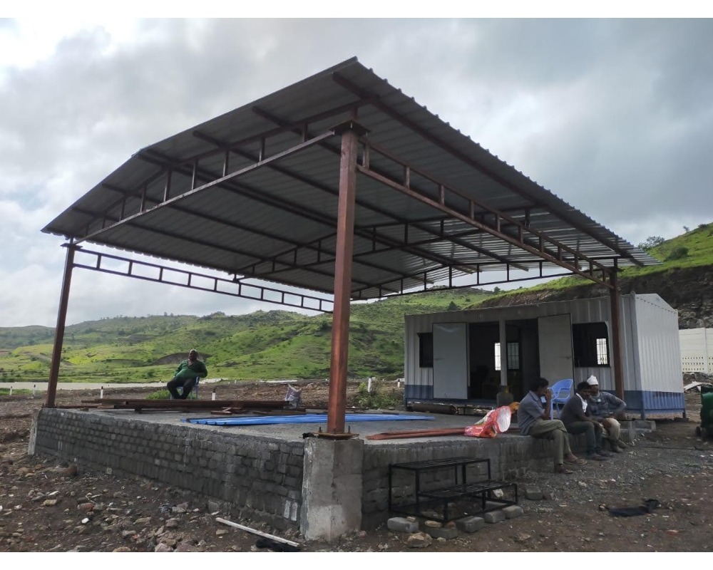 Illustration showcasing a modern industrial building with a sleek roofing shed designed and fabricated by Om Engineers (Fabricator). The roofing shed provides shelter and protection while adding to the architectural aesthetics of the structure.